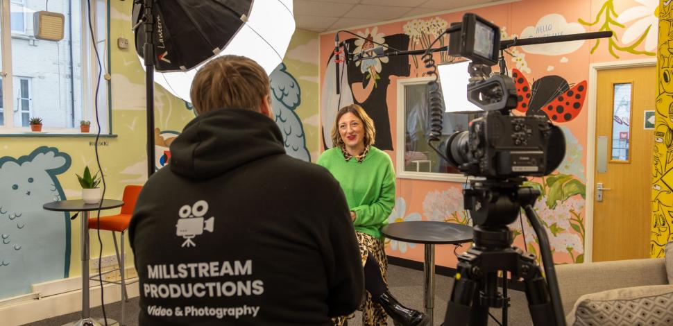 Louis filming interview with client in a workplace