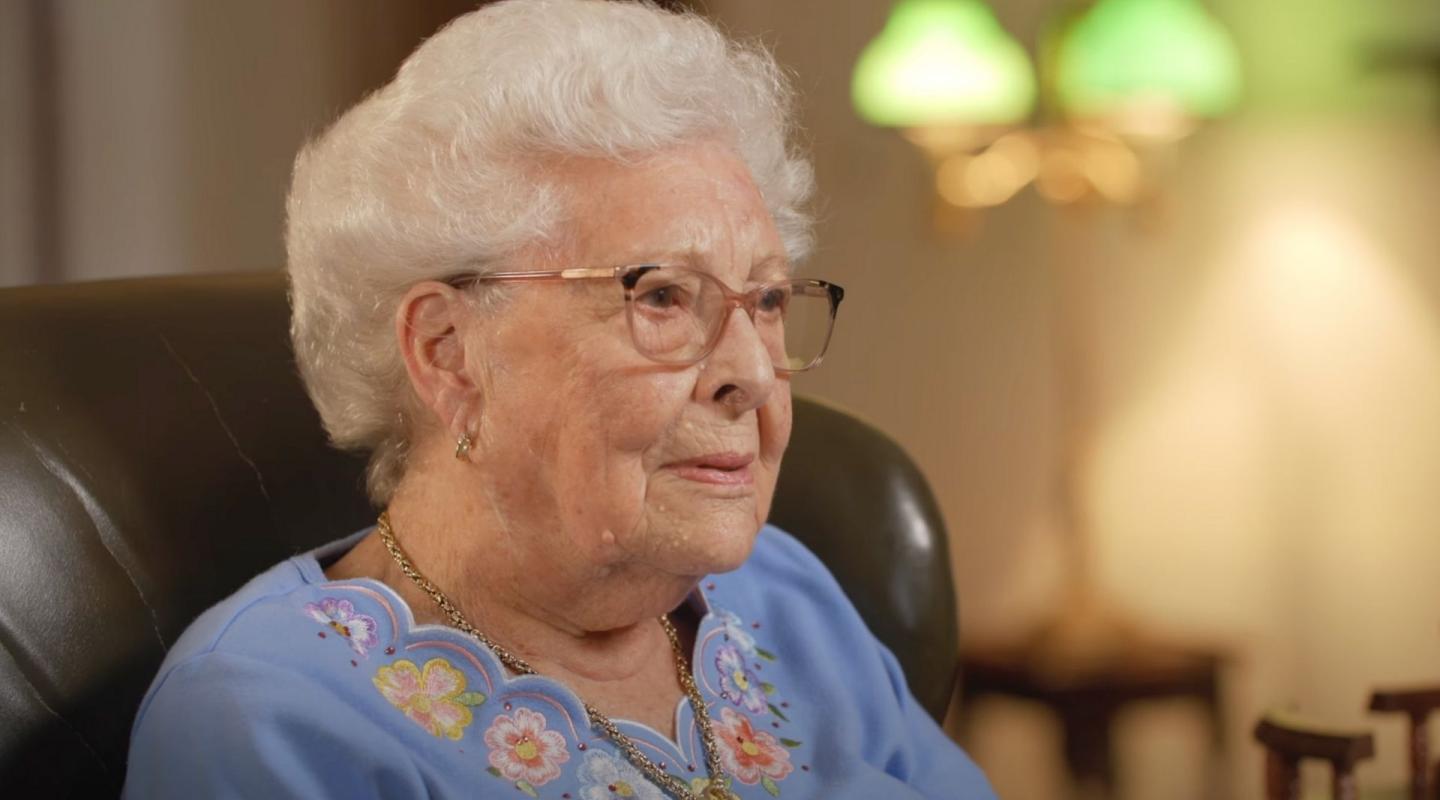 Lady being interviewed in an arm chair at home