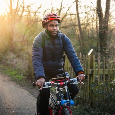man cycling along a road in wokingham