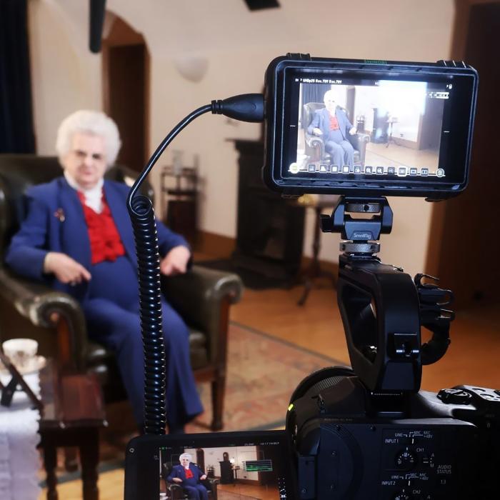 Older lady on camera, siting in an arm chair