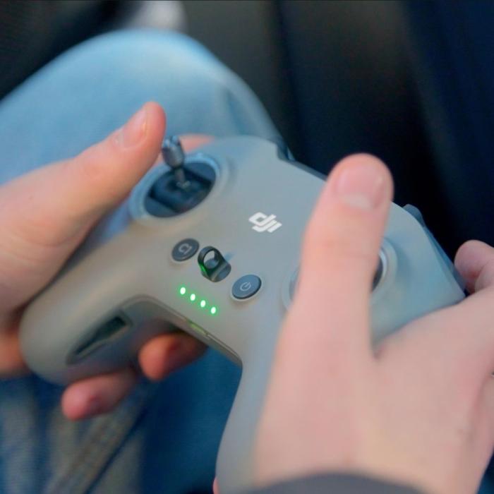 close up shot of hands operating a drone control