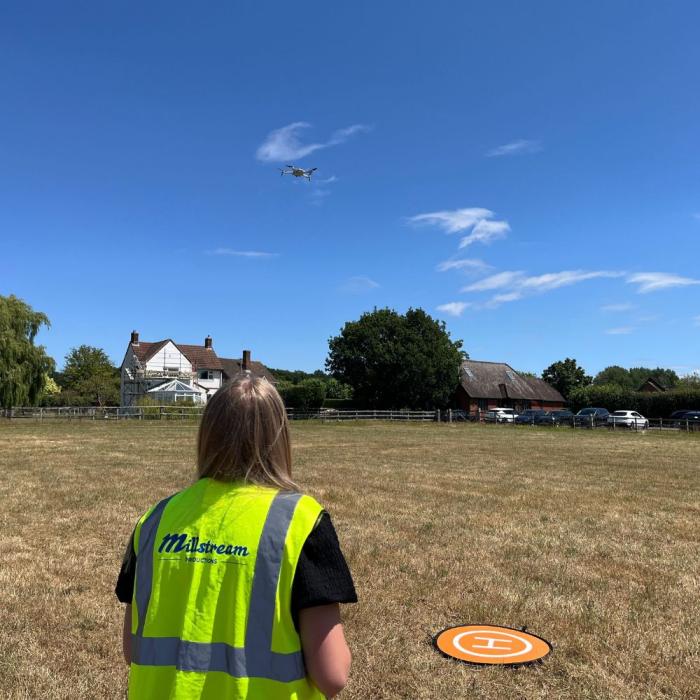 lauren flying the drone and looking up in the sky