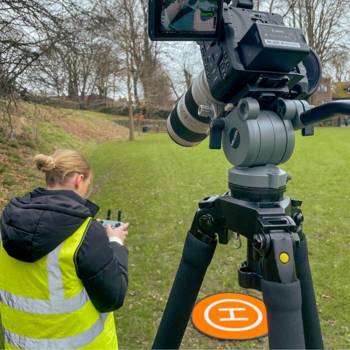 lauren flying the drone in a field
