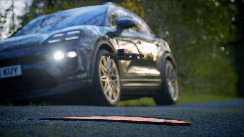 porsche with fpv drone and landing pad