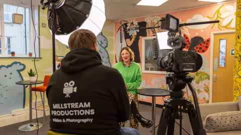 Louis filming interview with client in a workplace
