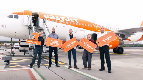 Staff at Southampton Airport and easyJet holding signs announcing three new routes