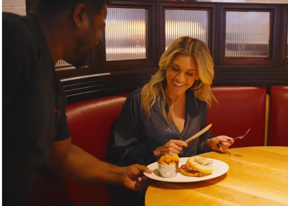 Ashley Roberts being served food in restaurant