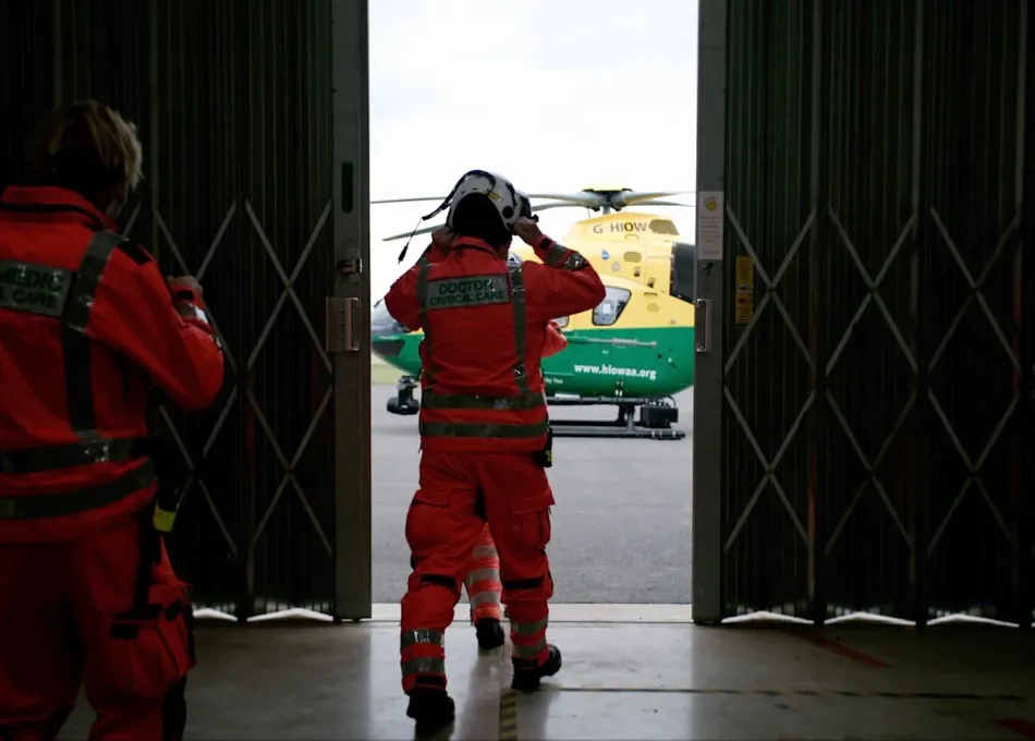 Air ambulance crew getting ready to board helicopter