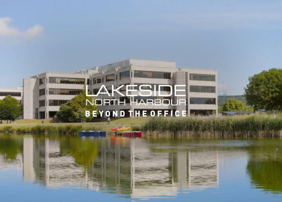 Office building next to lake in the summer time