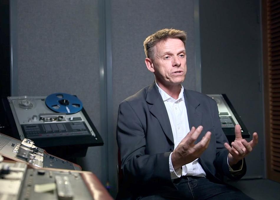 Man sat in recording studio being interviewed
