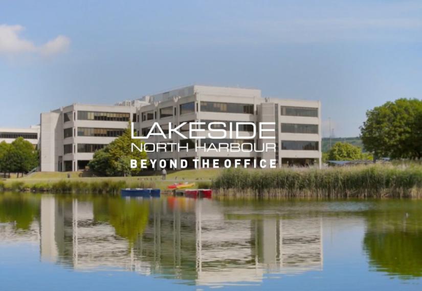 Office building next to lake in the summer time