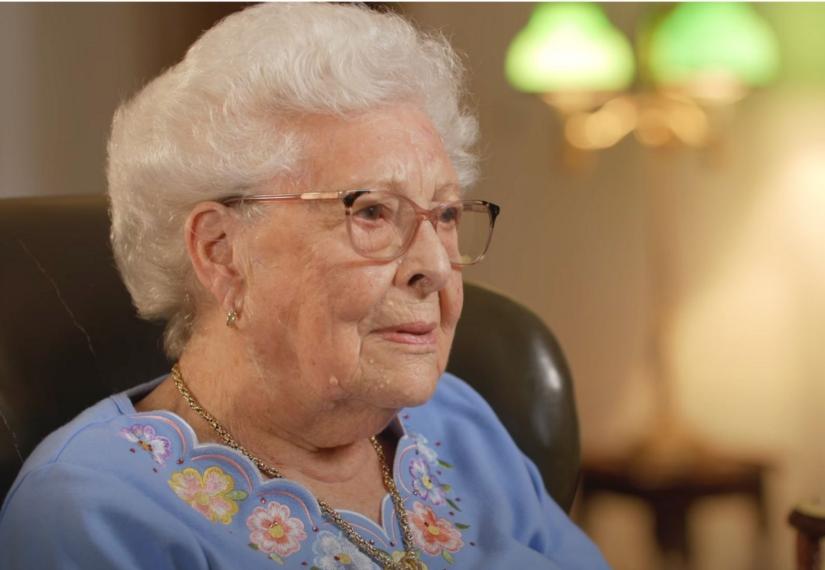 Lady being interviewed in an arm chair at home