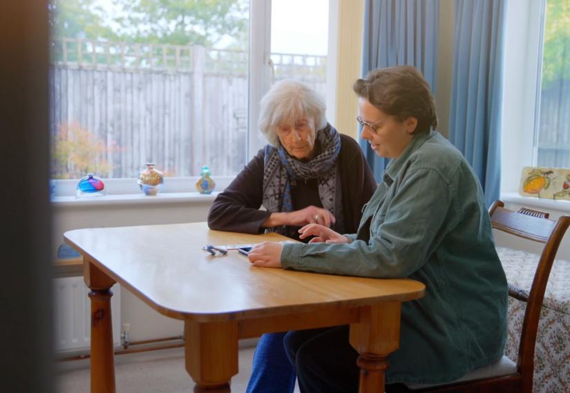 karen and brenda sat at a table together looking at the equipment