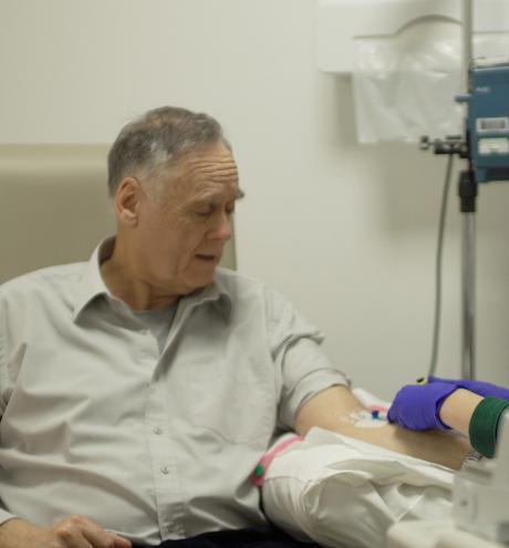 Man receieving medical care from a nurse in hospital