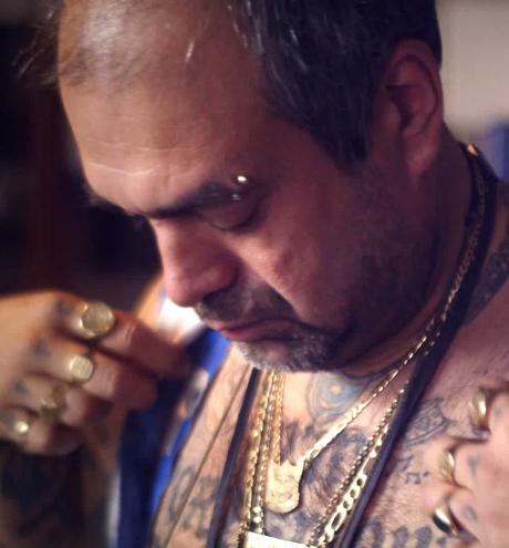 Football fan with tattoos putting on clothes