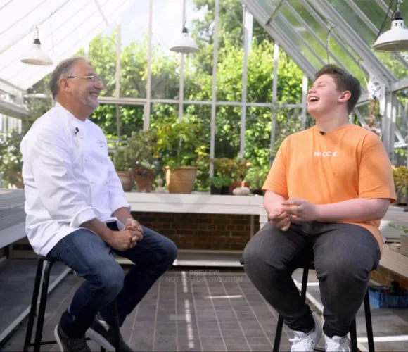 Chef Raymond Blanc chatting to young adult