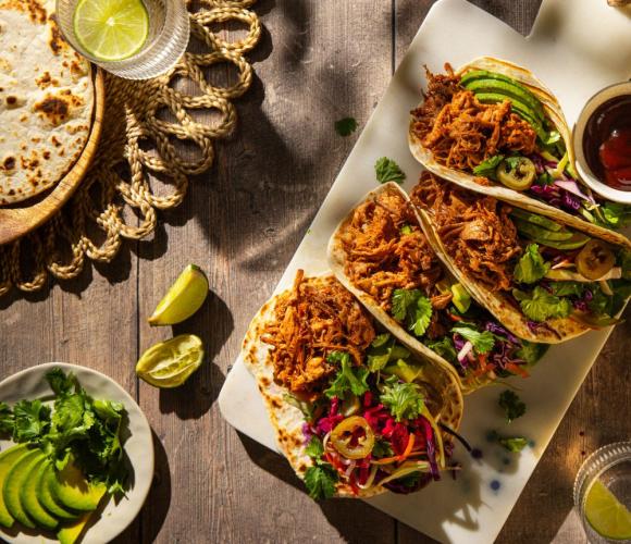 Pulled pork tacos on a wooden counter top