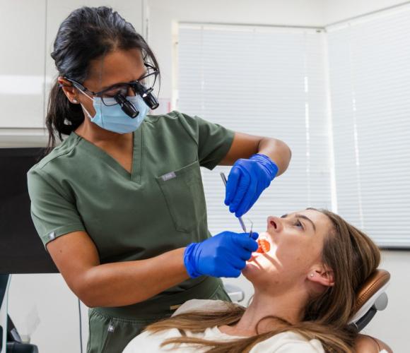 Dentist looking into the mouth a patient