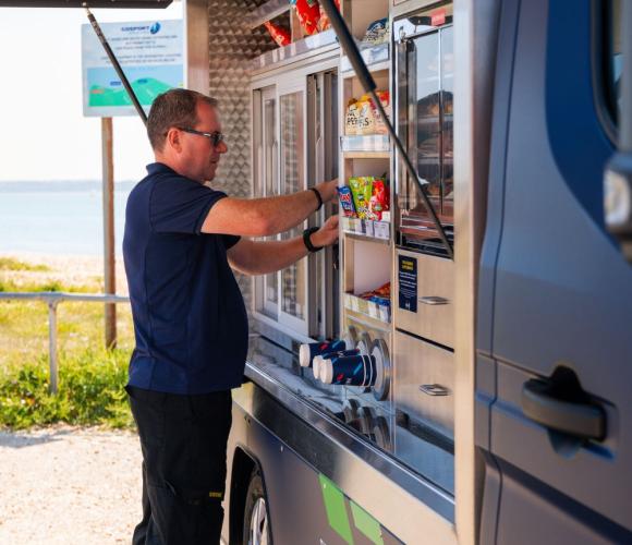 Someone setting up the NAAFI van service counter