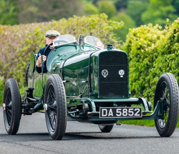 Sunbeam car being driven along a country lane