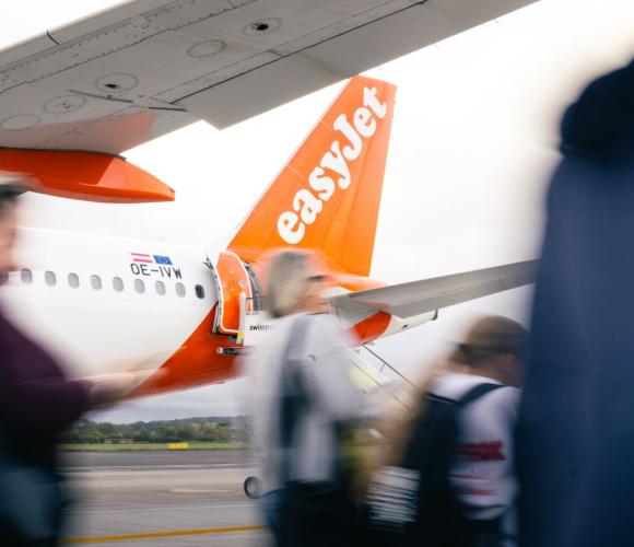 the back of an easyjet plane with people walking in front