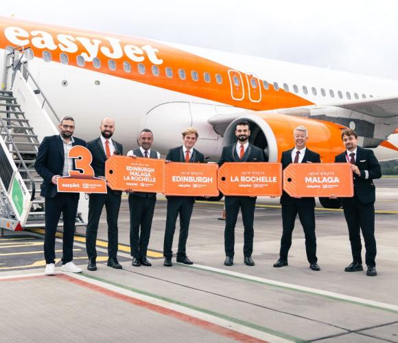 easyjet and southampton airport staff holding signs in front of an easyjet plane