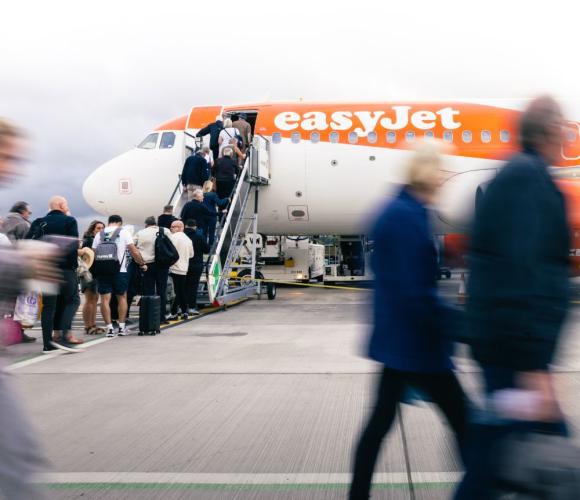 people queueing to get on an easyjet plane