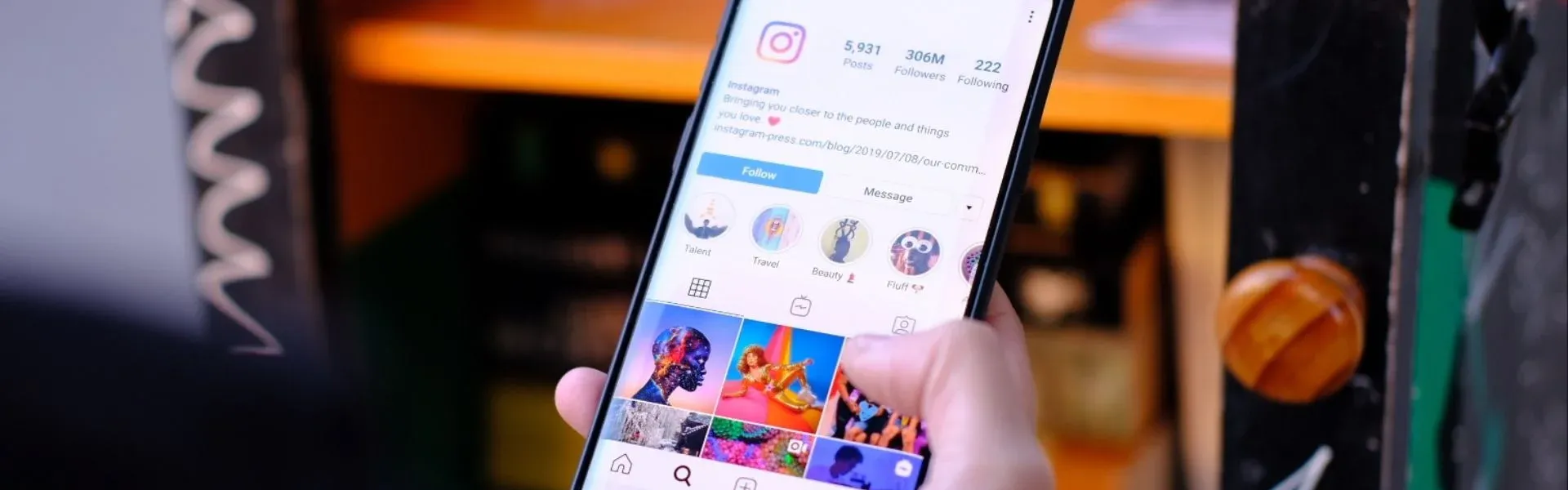Photograph: Smartphone held in hand, displaying the Instagram app with a feed of colourful images.