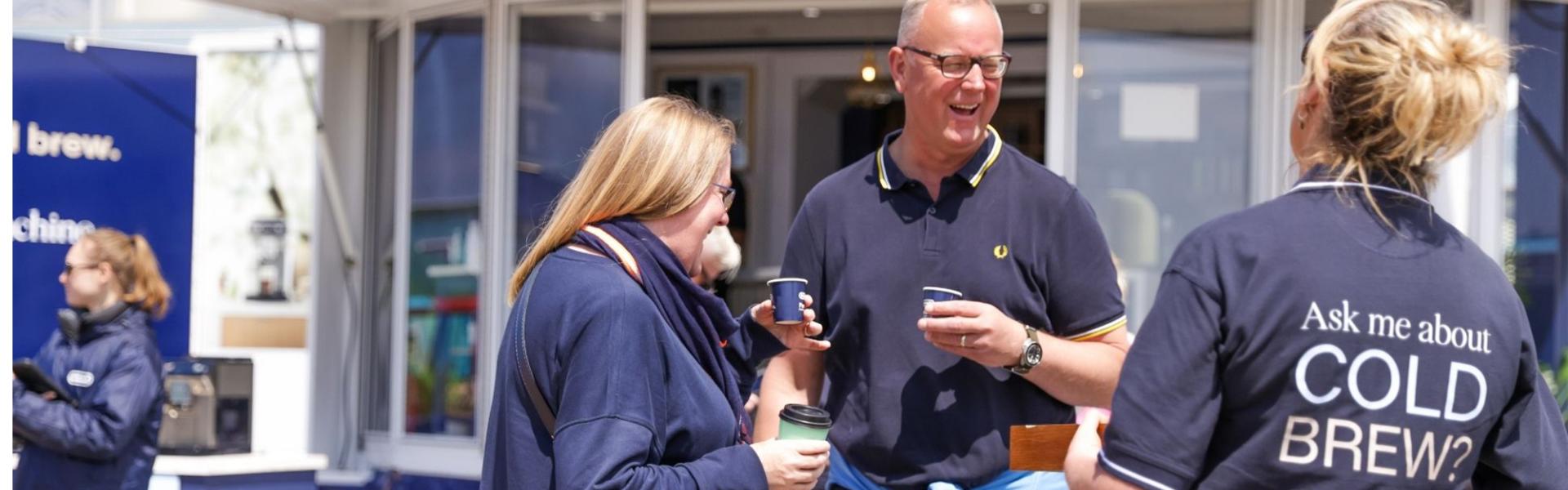 Coffee barista serving cold brew coffee outside to the public