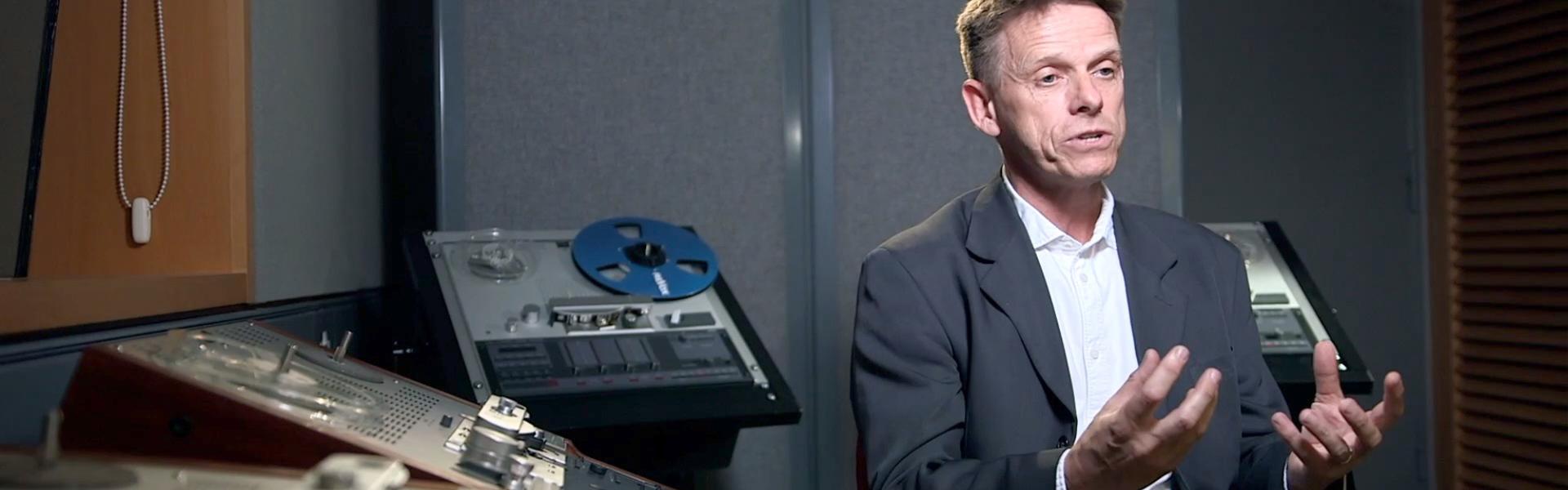 Man sat in recording studio being interviewed