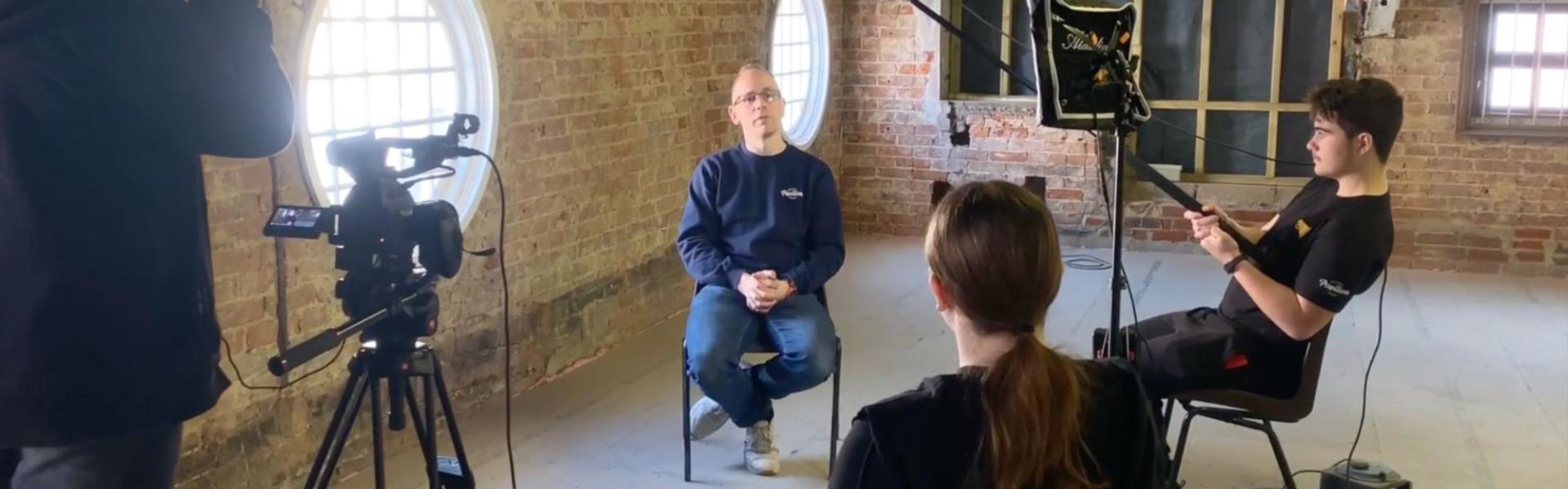 Man being interviewed by student film makers