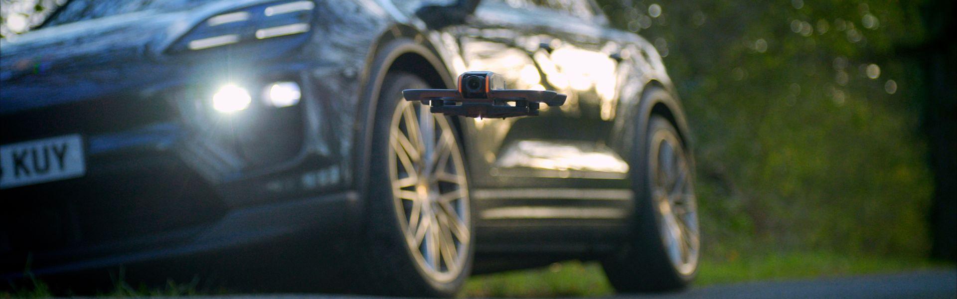 porsche with fpv drone and landing pad